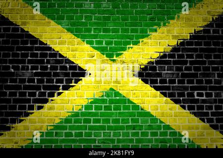 An image of the Jamaica flag painted on a brick wall in an urban location Stock Photo