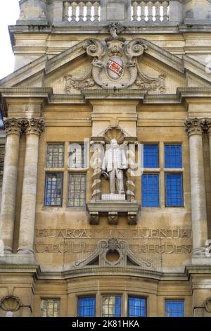 Oriel College, one of the university colleges in the city of Oxford showing the front of the building with the statue of Cecil Rhodes above the main e Stock Photo