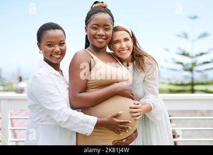 Id never want to celebrate with anyone else. a group of women taking photos during a baby shower. Stock Photo