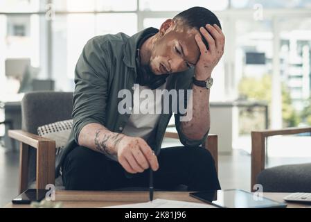 It is the courage to continue that counts. a young business man having a stressful day at work. Stock Photo