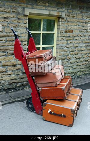 Old fashioned suitcases on hand cart, on Haworth Station on Keighley& Worth Valley Railway Stock Photo