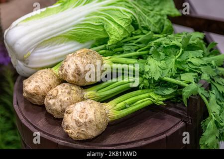 Fresh celery root with stalk with green leaves and Chinese cabbage. Healthy salad ingredients. Vegetarian food. Stock Photo