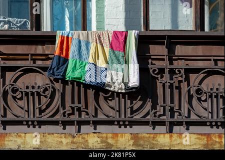Rusty balcony balustrade with colorful rug on Stock Photo