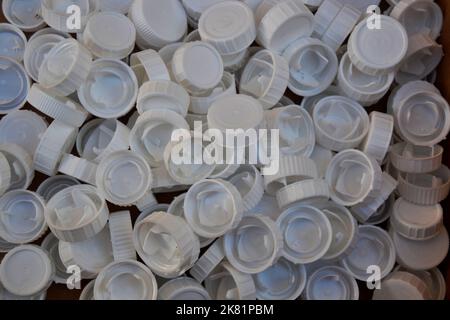 Background made with many white plastic bottle caps Stock Photo