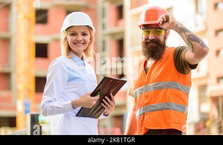 Purchase of building materials. Construction industry. Foreman established supply of building materials. Expert and builder communicate about supply Stock Photo