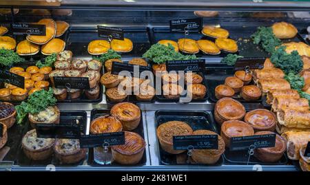 Conwy, United Kingdom - 27 August, 2022: close-up view of a butcher shop showcase with a variety of steak and pork pies Stock Photo