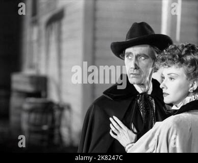 John Carradine & Margaret Lindsay Film: Alaska (USA 1944) Characters: John Reagan, Roxie Reagan  Director: George Archainbaud 18 November 1944   **WARNING** This Photograph is for editorial use only and is the copyright of MONOGRAM PICTURES and/or the Photographer assigned by the Film or Production Company and can only be reproduced by publications in conjunction with the promotion of the above Film. A Mandatory Credit To MONOGRAM PICTURES is required. The Photographer should also be credited when known. No commercial use can be granted without written authority from the Film Company. Stock Photo