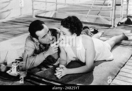 Humphrey Bogart & Mary Astor Film: Across The Pacific (1942) Characters: Rick Leland & Alberta Marlow  04 September 1942   **WARNING** This Photograph is for editorial use only and is the copyright of WARNER BROS and/or the Photographer assigned by the Film or Production Company and can only be reproduced by publications in conjunction with the promotion of the above Film. A Mandatory Credit To WARNER BROS is required. The Photographer should also be credited when known. No commercial use can be granted without written authority from the Film Company. Stock Photo