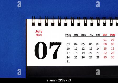 July 2023 Monthly desk calendar for 2023 year on blue background. Stock Photo