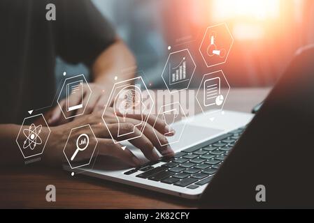 Businessman using laptop computer icon virtual screen education online and e learning on desk. Stock Photo