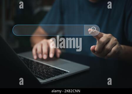 man hand searching browsing for information internet data Technology on computer keyboard notebook.SEO Search Engine Optimization. Stock Photo