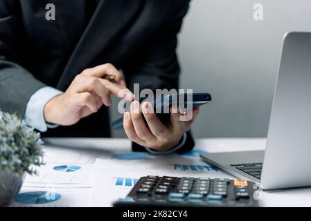 Businessman using smartphone marketing laptop computer business network manager. man using notebook internet online technology communication. Stock Photo