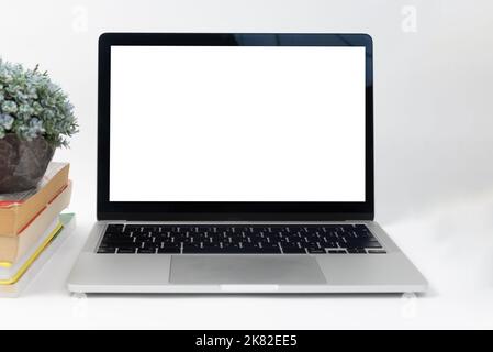 Mockup computer laptop display blank screen on desk in office. Stock Photo