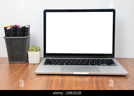 Mockup computer laptop display blank screen on desk in office. Stock Photo