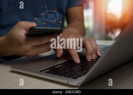 Men hands using mobile phone typing Live chat chatting and social network. chatting application working in chat box icons.Social media marketing techn Stock Photo