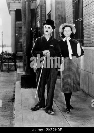 Charlie Chaplin & Paulette Goddard Film: Modern Times (USA 1936) Characters: & A Gamin  Director: Charles Chaplin 05 February 1936   **WARNING** This Photograph is for editorial use only and is the copyright of CHARLES CHAPLIN PRODUCTIONS and/or the Photographer assigned by the Film or Production Company and can only be reproduced by publications in conjunction with the promotion of the above Film. A Mandatory Credit To CHARLES CHAPLIN PRODUCTIONS is required. The Photographer should also be credited when known. No commercial use can be granted without written authority from the Film Company. Stock Photo