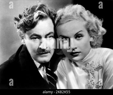 John Barrymore & Carole Lombard Film: Twentieth Century (1934) Characters: Oscar Jaffe, Lily Garland aka Mildred Plotka  Director: Howard Hawks 03 May 1934   **WARNING** This Photograph is for editorial use only and is the copyright of COLUMBIA PICTURES and/or the Photographer assigned by the Film or Production Company and can only be reproduced by publications in conjunction with the promotion of the above Film. A Mandatory Credit To COLUMBIA PICTURES is required. The Photographer should also be credited when known. No commercial use can be granted without written authority from the Film Comp Stock Photo