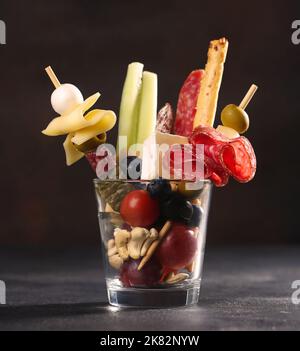 Jarcuterie in a glass, the modern version of charcuterie with various types of sausages and cheese Stock Photo