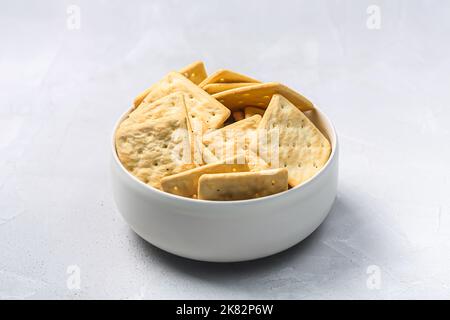 Bowl of dry crackers isolated on gray background with shadow Stock Photo
