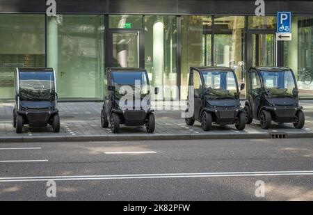 Amsterdam, The Netherlands, 06.10.2022, Modern electric micro cars, called also as quadricycles, parked in the street Stock Photo