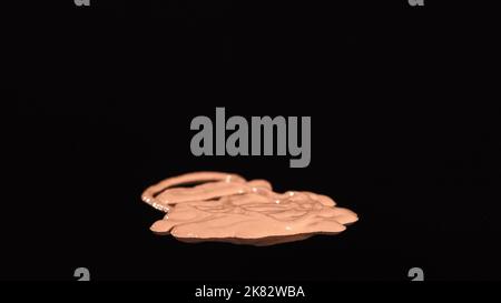 Close up view of beige makeup concealer on black background Stock Photo