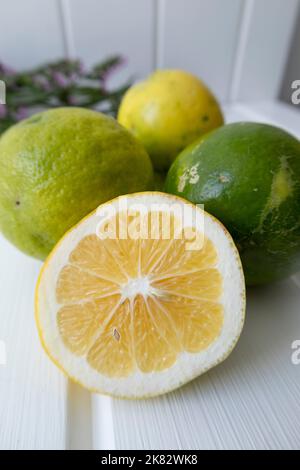 fresh whole lemons and one cut, citrus fruit with vitamin c, ingredient for healthy diet in studio Stock Photo