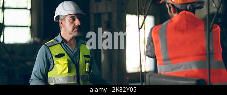 industrial factory with men at work concept, professional engineer foreman inspector talking in business occupation job teamwork with team, constructi Stock Photo
