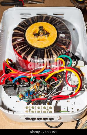 Voltage stabilizer repair. Multi-colored wires in a white casing of the Centurion stabilizer:Russia,Anapa-20.10.2022 Stock Photo