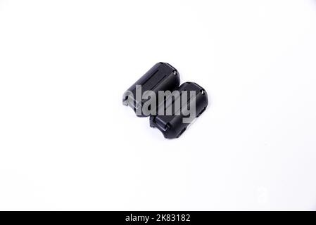 Close up of a ferrite bead inductor. An electrical element that suppresses high-frequency electronic noise in electronic circuits. on isolated white Stock Photo