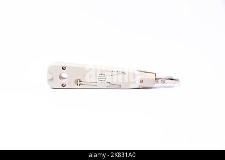Hand crimp tool for crimping of the round terminals and small heap of blue insulated terminals on a white background Stock Photo