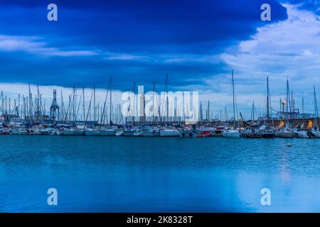 Marina of the port of Sète and its lighthouse, on a stormy evening, in Occitanie, in France Stock Photo