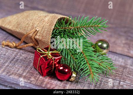 Jute bag with spruce branch and Christmas decoration Stock Photo