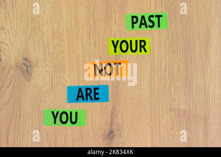 You are not your past symbol. Concept words You are not your past on colored paper. Beautiful wooden background. Business and you are not your past co Stock Photo