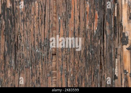 Detail of Old, worn plywood wall with worn black paint background Stock Photo