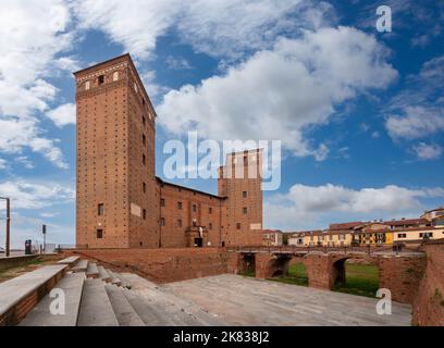 Fossano, Piedmont, Italy - october 20, 2022: the Castle of the Princes of Acaja (14th century) with the towers, the moat and the access bridge on blue Stock Photo