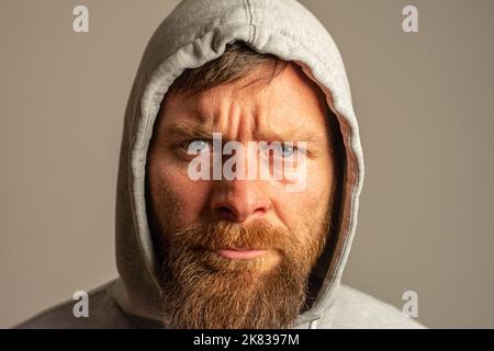 man with hood on a dark background depression or hacker Stock Photo