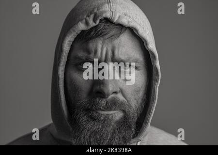 man with hood on a dark background depression or hacker Stock Photo