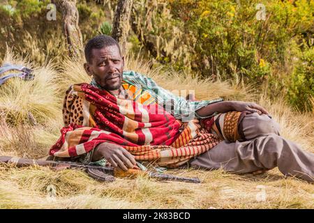 SIMIEN MOUNTAINS, ETHIOPIA - MARCH 16, 2019: Armed scout guarding tourists in Simien mountains, Ethiopia Stock Photo