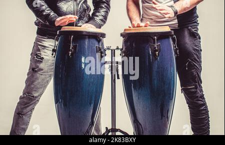 Performers playing bongo drums. Close up of musician hand playing bongos drums. Afro-Cuba, rum, drummer, fingers, hand, hit. Drum. Hands of a musician Stock Photo