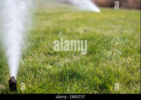 winterizing a irrigation sprinkler system by blowing pressurized air through to clear out water Stock Photo