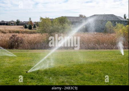 winterizing a irrigation sprinkler system by blowing pressurized air through to clear out water Stock Photo