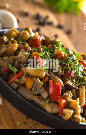 Mushroom stew with a lot of vegetables on wood - close up view Stock Photo