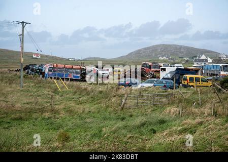 Abandoned vehicles rusting in a field at Eoligarry on the Isle of Barra in the Outer Hebrides, Scotland, UK. Stock Photo