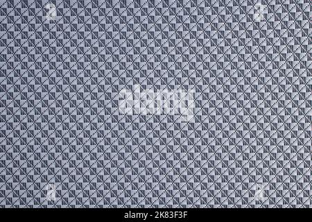 Close-up of diamond-patterned textured synthetic fabric used to make blinds. Design template or polyester material abstract background. Stock Photo