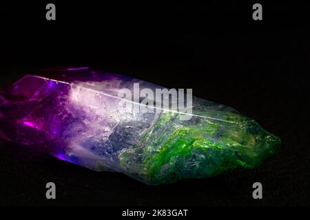 Vibrant colorful Cocktail aura quartz point macro isolated on a black surface. Colorful, pink, blue, white, purple and green man-enhanced Stock Photo