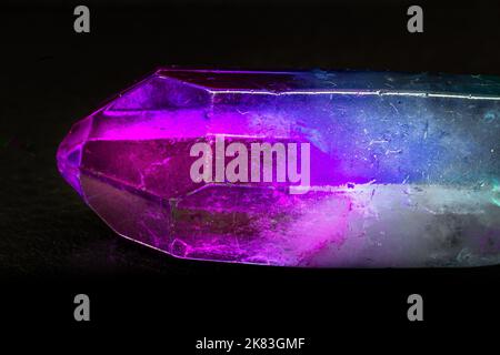 Vibrant colorful Cocktail aura quartz point macro isolated on a black surface. Colorful, pink, blue, white, purple and green man-enhanced Stock Photo
