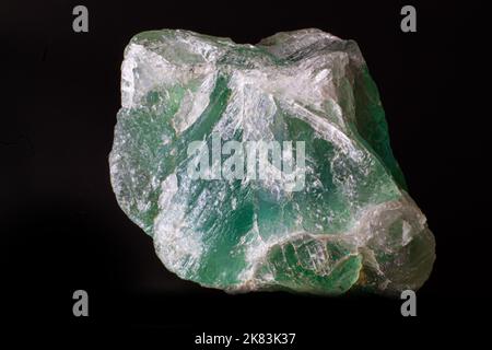 Macro rough green fluorite stone  isolated on black surface Stock Photo