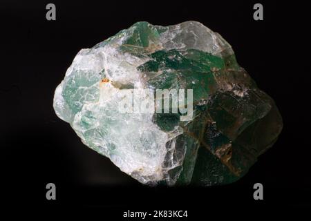 Macro rough green fluorite stone  isolated on black surface Stock Photo