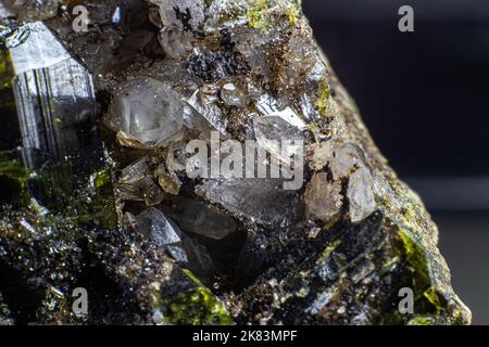 Ultra macro picture of small quartz points with one dark green epidote spike on matrix Stock Photo