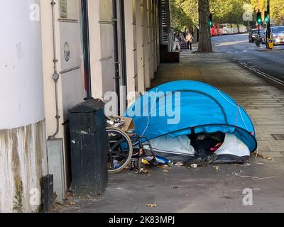 London, UK. 19th October, 2022. A homeless person sleeps in their tent under a bridge on the Embankment oppsite the River Thames. As the cost of living crisis worsens, more people are becoming homeless. Credit: Maureen McLean/Alamy Stock Photo